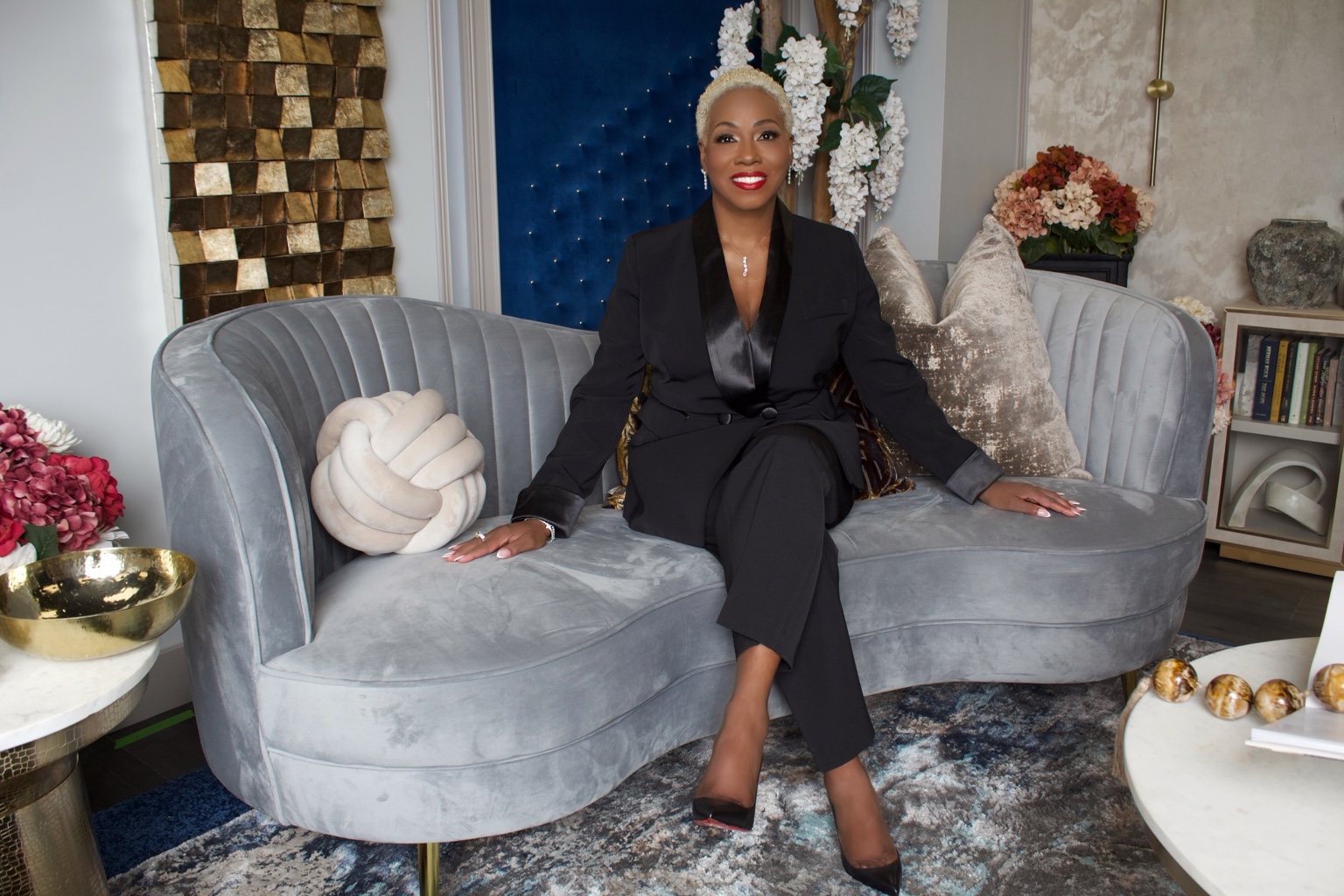 Business leader in a black suit seated in a contemporary lounge