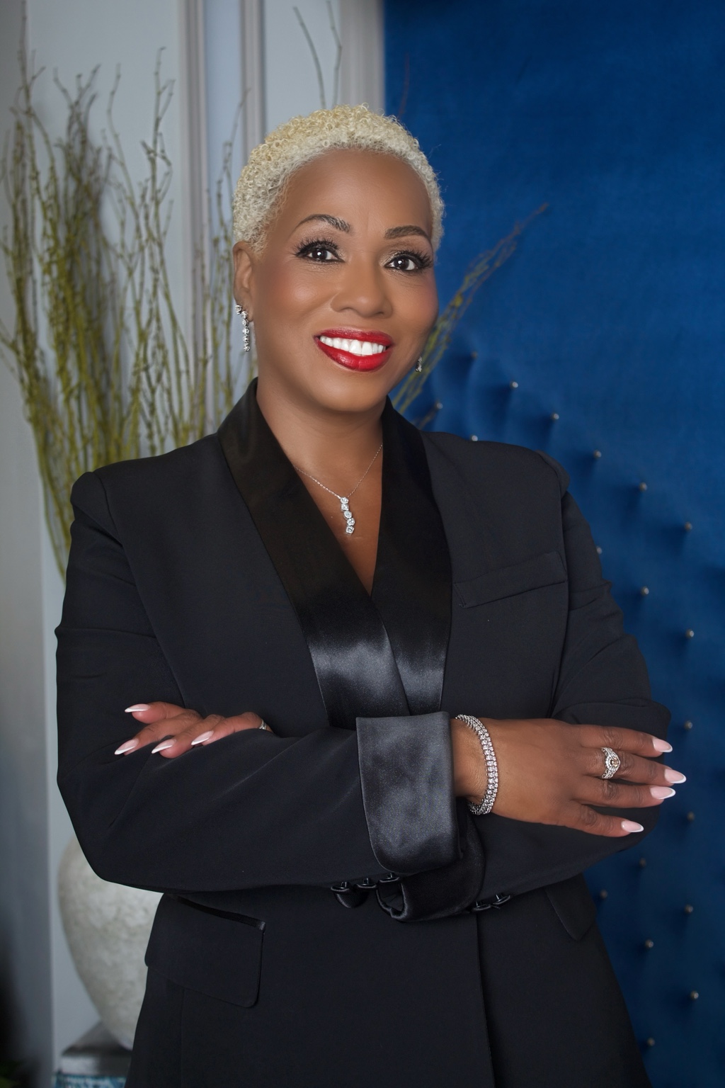 Business leader in a black suit with arms crossed