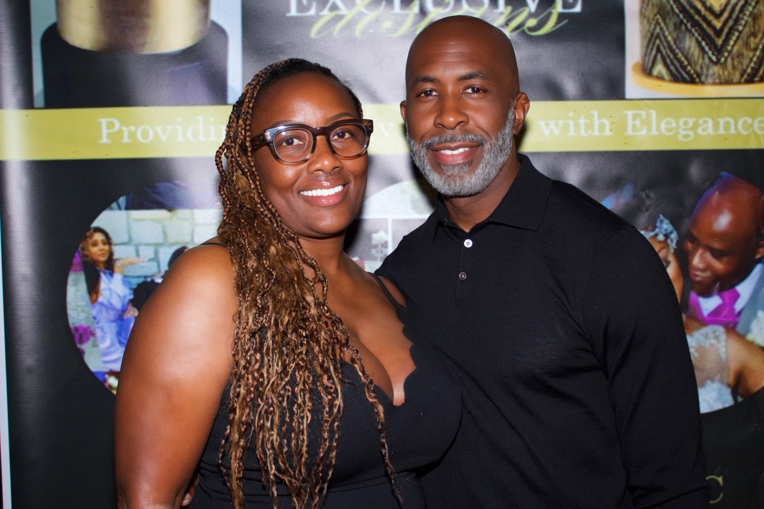 Two smiling guests pose together at a celebration