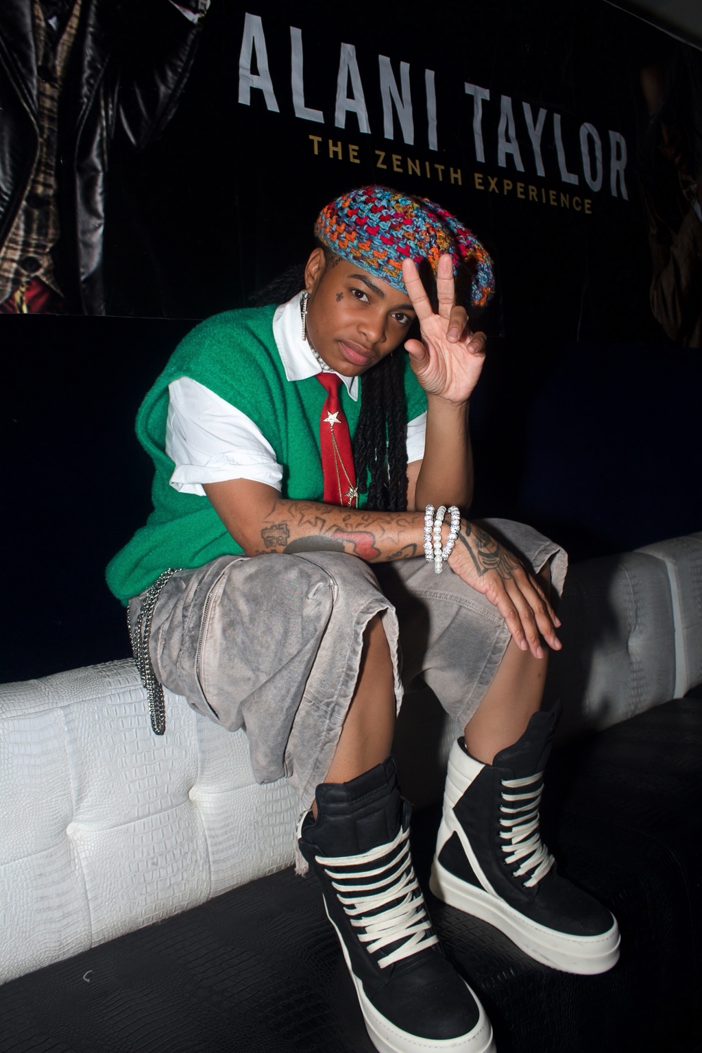 Guest in colorful streetwear seated at an event