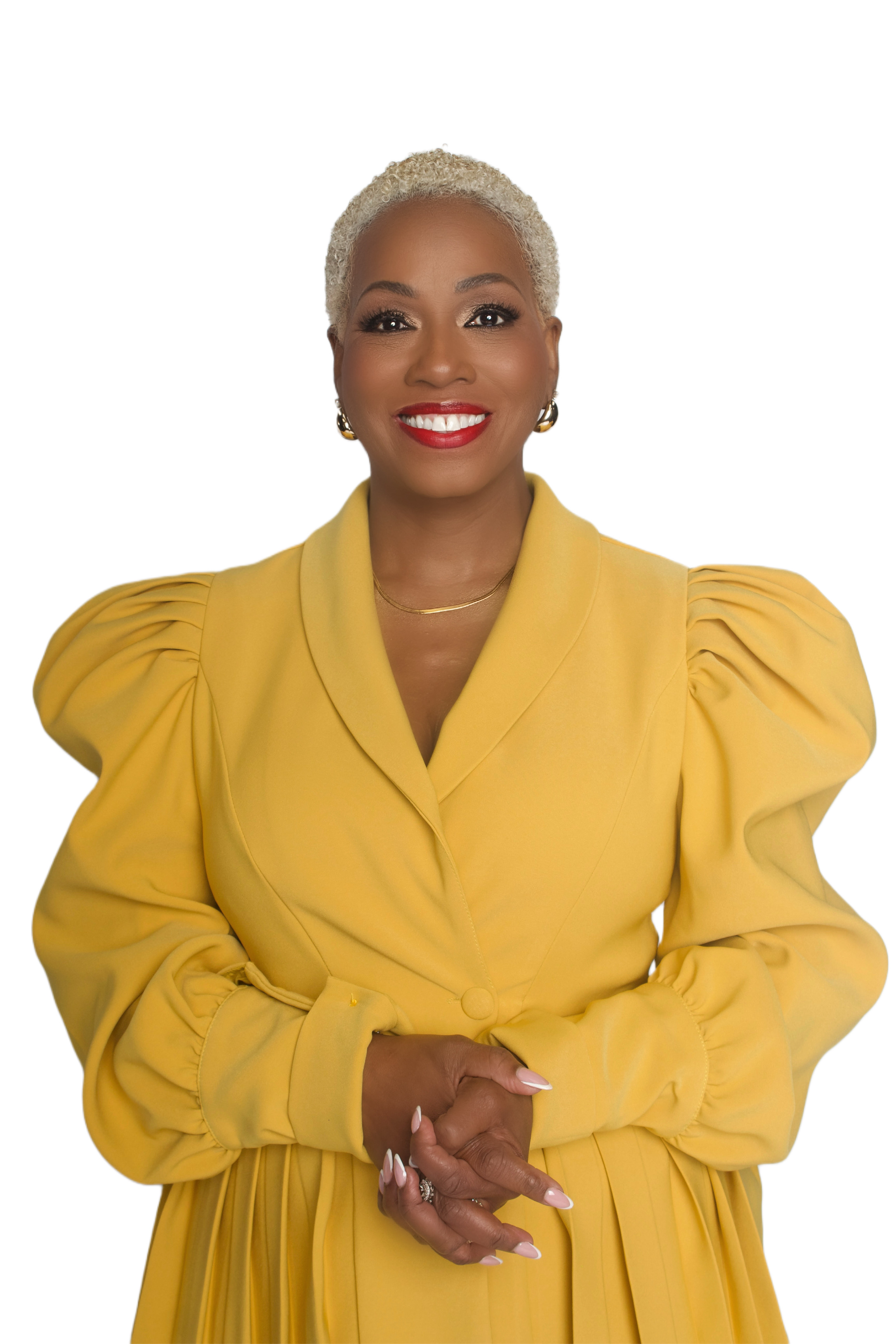 Confident founder smiling in a yellow outfit against a white background